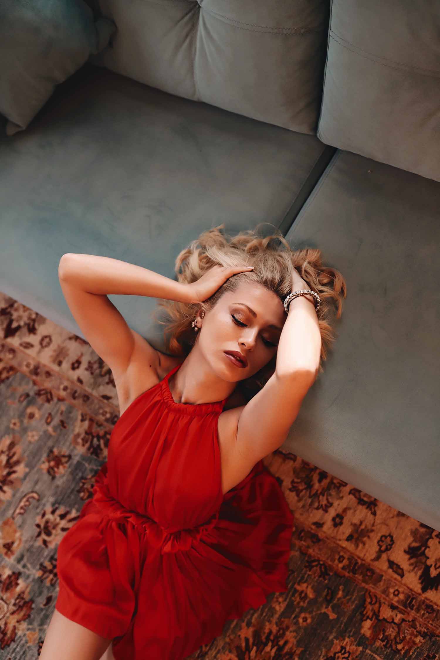 a person lying on a couch with her hands behind her head